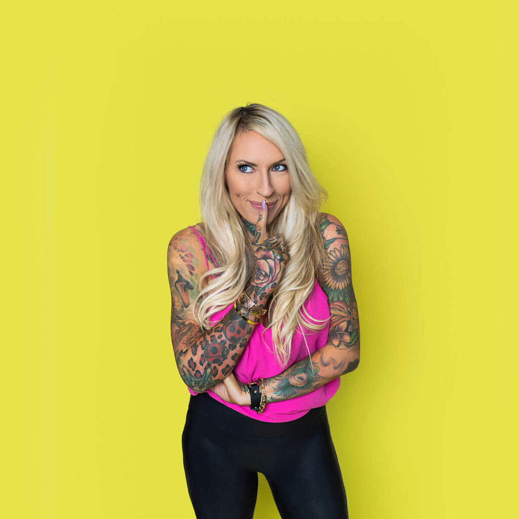Expressive studio photo of a business owner posing confidently against a colourful lime green backdrop
